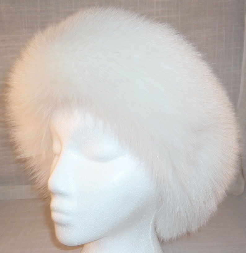 May include: A white fur headband. The headband is made of soft, fluffy fur and is ideal for keeping your ears warm in the winter.