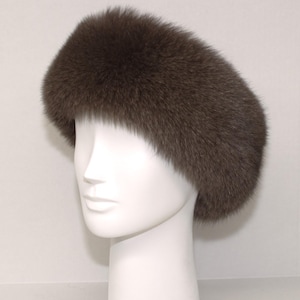 May include: A brown fur headband. The headband is made of soft, fluffy fur and is designed to keep your ears warm.