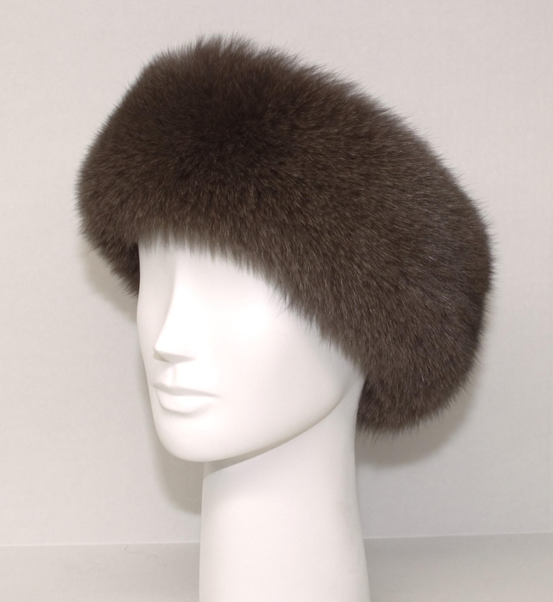 May include: A brown fur headband. The headband is made of soft, fluffy fur and is designed to keep your ears warm.