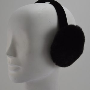 May include: Black fur earmuffs with a black velvet headband. The earmuffs are soft and fluffy.