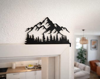 Door frame decoration Alpine landscape with mountain silhouette and fir trees as a minimalist winter scene, handmade wall decoration