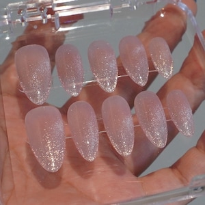 May include: A set of three ceramic mugs with a speckled, matte finish. The mugs are in shades of cream, light gray, and dark gray. Each mug has a simple, minimalist design, perfect for coffee or tea.