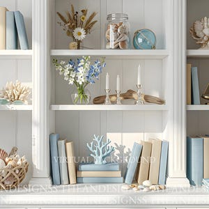 May include: A white bookshelf filled with coastal decor. Items include books in various shades of blue and beige, seashells, coral, a glass jar with shells, and a small sailboat. Dried flowers and candles add to the aesthetic.