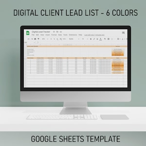 May include: A computer monitor displays a Google Sheets template titled "Digital Client Lead List - 6 Colors." The spreadsheet is filled with data, and the text "GOOGLE SHEETS TEMPLATE" is at the bottom. A keyboard and mouse pad are in front of the monitor.