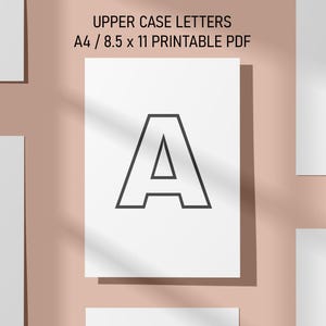 May include: White paper prints with black outline uppercase letters A, B, and C. The text "UPPER CASE LETTERS A4 / 8.5 x 11 PRINTABLE PDF" is at the top. The background is a light pink color.