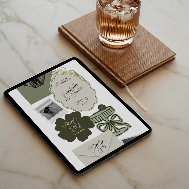May include: A digital tablet displaying a wedding invitation design with the names "Arabella & James" and the date "13 July 2021, Lake Como, Italy". The design includes floral elements and a photo. A glass of water and a brown notebook are also visible.
