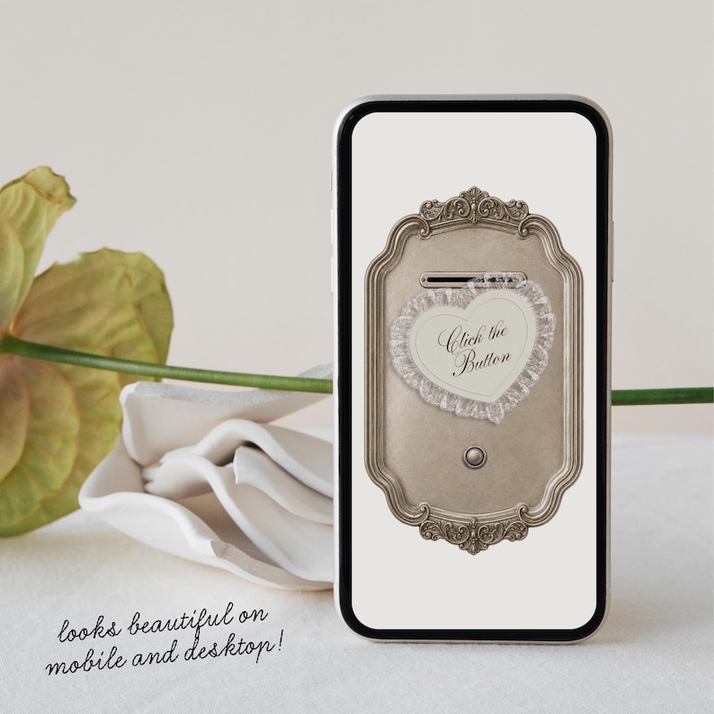 May include: A smartphone screen displaying a digital graphic of a rectangular, ornate, metallic-toned frame with a heart-shaped lace border. Inside the heart, the text reads Click the Button. Below the frame, the text reads looks beautiful on mobile and desktop!