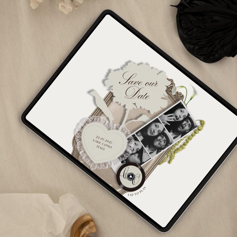May include: A digital tablet screen displaying a Save the Date announcement with a vintage frame, a black and white photo strip, a heart-shaped tag with the text 22.07.2027 LAKE COMO ITALY, a bird silhouette, and a circular icon labeled TAP TO PLAY.