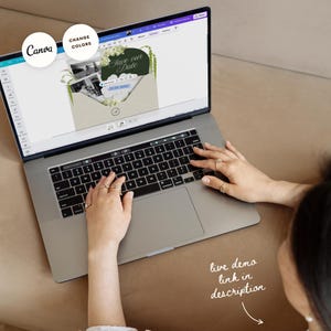 May include: A laptop displaying a wedding invitation design with the text "Save the Date." The design features a green and white floral arrangement. The Canva logo and "Change Colors" text are visible. The text "live demo link in description" is also visible.