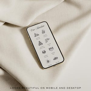 May include: A smartphone displaying a wedding timeline with illustrations and text. The phone has a gold frame and is set against a neutral fabric background. The text at the bottom reads "LOOKS BEAUTIFUL ON MOBILE AND DESKTOP."