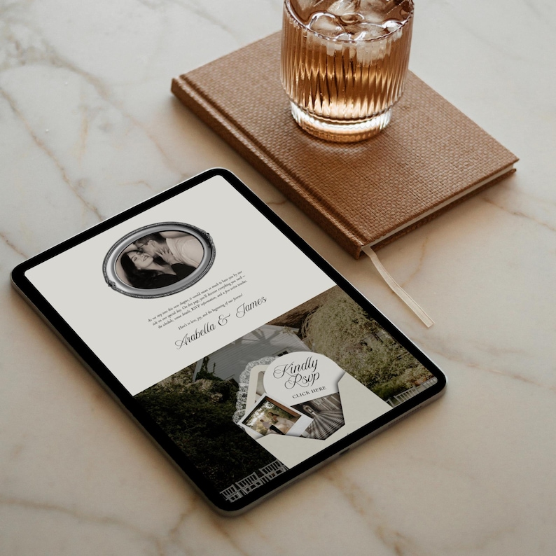May include: A digital tablet displaying a wedding invitation with the names "Arabella & James." The invitation features a black and white photo, decorative text, and a "Kindly RSVP" section. A glass of water and a brown notebook are in the background.
