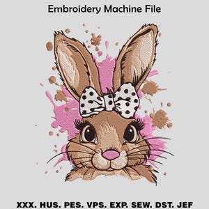 May include: An embroidery machine file depicting a cartoon bunny with a white bow with black polka dots. The bunny has long eyelashes and is set against a pink and brown splatter background. The text "Embroidery Machine File" is at the top.