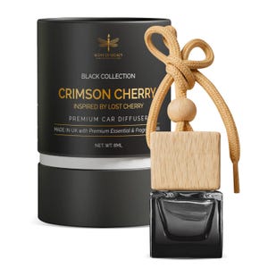 May include: A black car air freshener with a wooden top and a tan cord. The product is labelled "Crimson Cherry" and "Premium Car Diffuser." The packaging is black with gold text and a dragonfly logo. Net weight is 8ml.