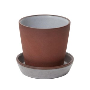 May include: A terracotta-colored ceramic planter with a light gray interior and a matching saucer. The planter has a cylindrical shape and a slightly flared rim. The saucer is round and has a raised edge.