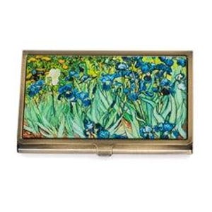 May include: A rectangular business card holder with a brass finish. The top features a vibrant print of Vincent van Gogh's "Irises" painting, showcasing blue irises and green foliage. The holder is approximately 4 inches long and 2.5 inches wide.