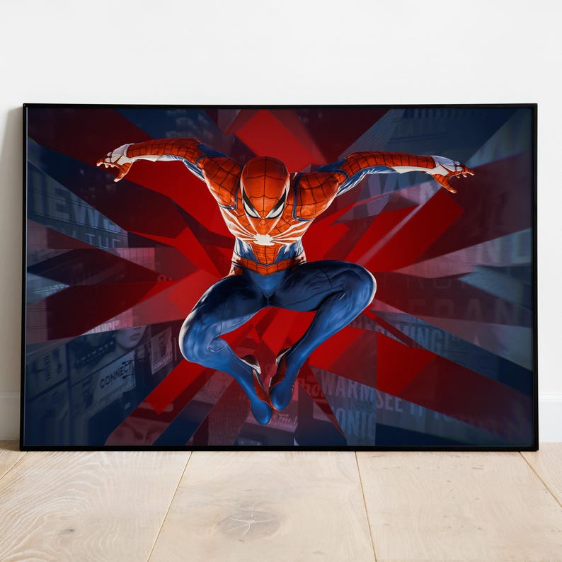 May include: Framed artwork featuring Spider-Man in a dynamic pose. The superhero is depicted in his classic red and blue suit, set against a backdrop of red and blue abstract shapes. The artwork is framed in a black border.