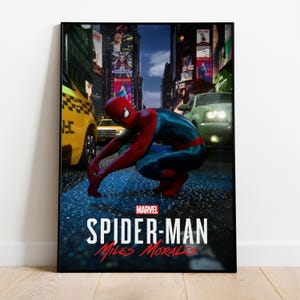 May include: A framed poster featuring Spider-Man in a crouched position on a wet street. The superhero is wearing a red and blue suit. The poster includes the Marvel logo and the text "SPIDER-MAN Miles Morales."