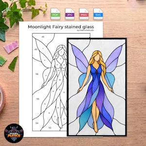 May include: A digital pattern for a Moonlight Fairy stained glass project, featuring a numbered black and white line art template alongside a finished, colorful version of the fairy with blue and purple wings and a flowing dress.