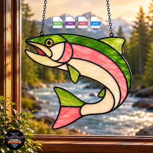 May include: A stained glass suncatcher shaped like a leaping fish with green, pink, and cream-coloured glass panels held together by black metal cames. The fish hangs from two black chains. Four small icons labelled PDF, JPG, PNG, and SVG are visible.