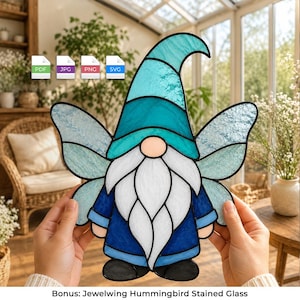May include: A stained glass gnome ornament featuring a tall teal hat, a long white beard, and dark blue clothing. The gnome has light blue wings extending from its sides. The piece is constructed with black lead lines and includes four file icons.
