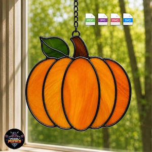 May include: A stained glass pumpkin suncatcher featuring vibrant orange glass segments with black lead lines, a brown stem, and a single green leaf. The piece hangs from a black metal chain, designed to catch light and display its textured glass.