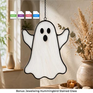 May include: A white stained glass ghost suncatcher with black glass eyes and a black mouth, outlined in black metal cames. The ghost hangs from a black metal chain. Above the ghost are four small square icons labeled PDF, JPG, PNG, and SVG.