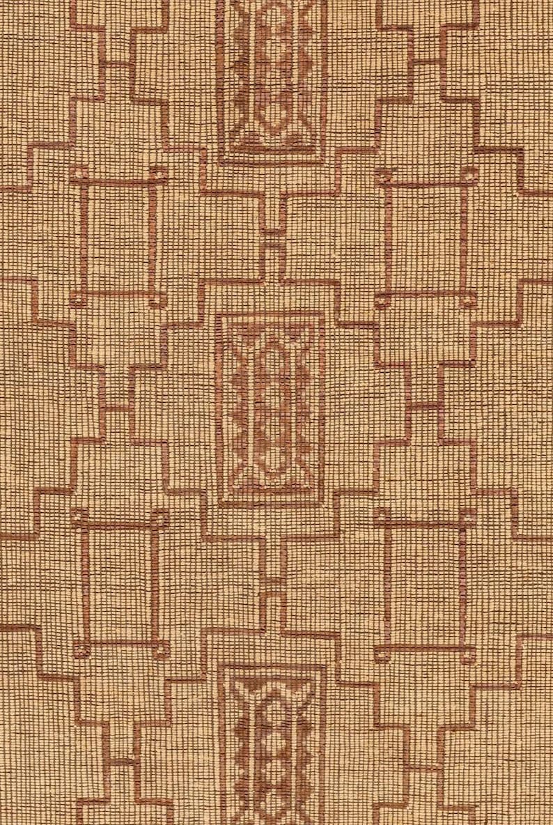 Eco friendly Tuareg jute rug with leather accents for minimalist bedroom decor and modern rustic interiorssuggesting a handmade or artisanal quality.