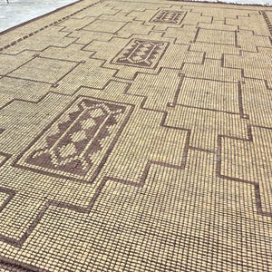 Handcrafted Moroccan woven rug with tribal geometric artwork and rustic natural jute texture for cozy interiors