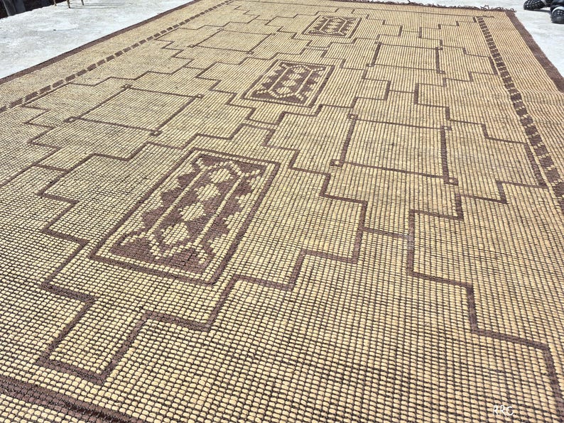 Handcrafted Moroccan woven rug with tribal geometric artwork and rustic natural jute texture for cozy interiors