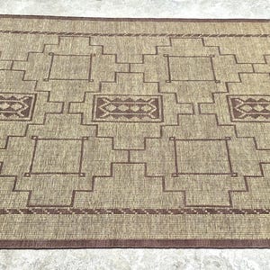 Rustic bohemian Tuareg rug with handwoven jute and leather details for luxury farmhouse bedroom decor