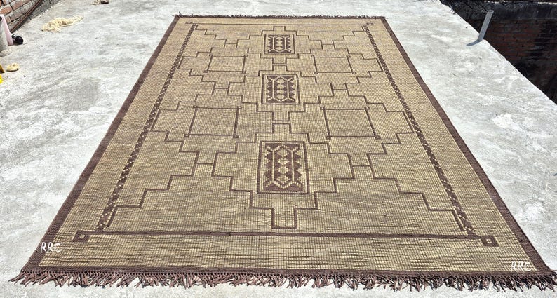 home decor and natural woven flooring
Large handmade Tuareg rug for living room featuring natural jute weave and brown leather detailing with tribal style
