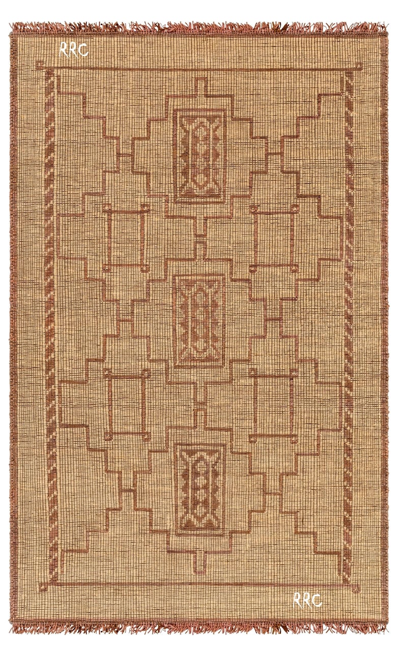 Minimalist natural fiber area rug with authentic Tuareg tribal design and handmade leather craftsmanship
