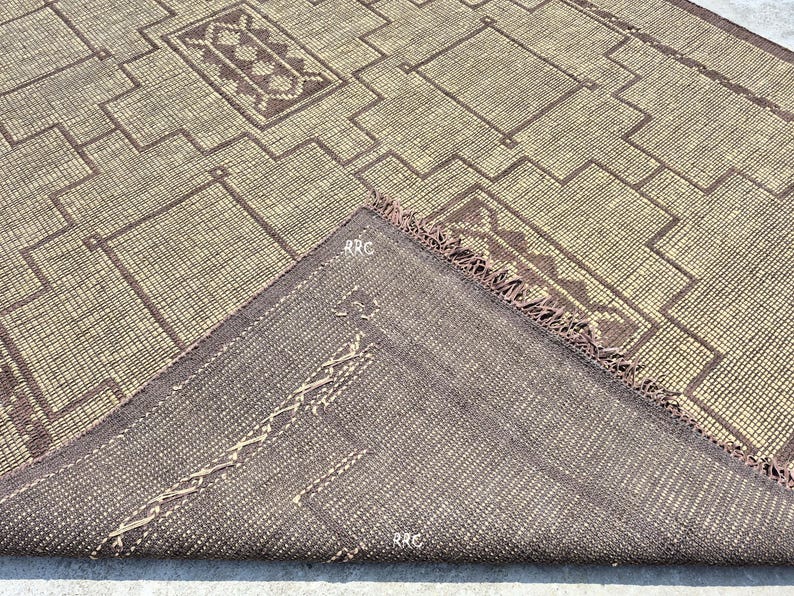 Handwoven Moroccan Tuareg carpet made from natural fiber jute and leather for bohemian floor decor ideas