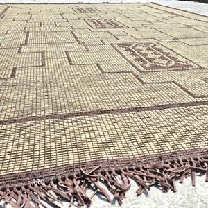 Modern tribal Moroccan carpet with natural woven jute texture and artisan leather accents for stylish interiors