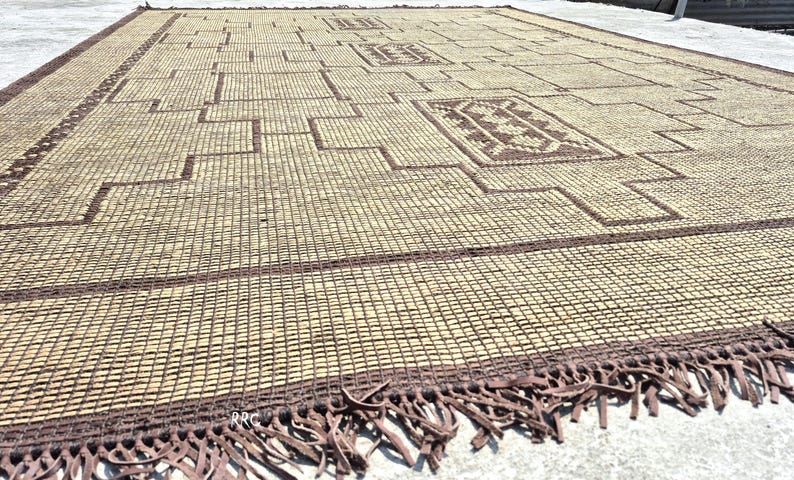 Modern tribal Moroccan carpet with natural woven jute texture and artisan leather accents for stylish interiors