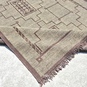 Handmade Tuareg jute and leather rug in modern boho living room with natural fiber tribal design and rustic Moroccan decor