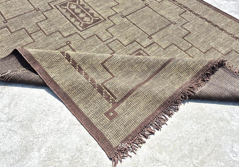 Handmade Tuareg jute and leather rug in modern boho living room with natural fiber tribal design and rustic Moroccan decor