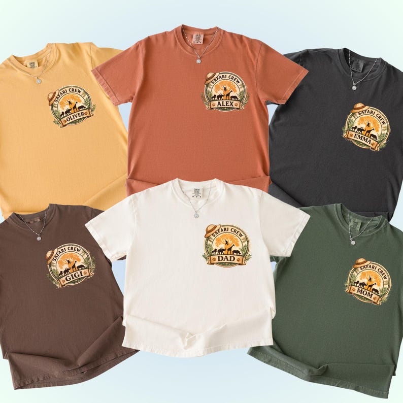 May include: A collection of six short-sleeved t-shirts in various colors, including yellow, orange, black, brown, white, and green. Each shirt features a "Safari Crew" graphic with a hat, animals, and a personalized name or title.