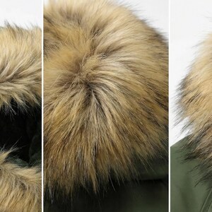 K&ouml;nnte beinhalten: Nahaufnahme einer gr&uuml;nen Parka-Kapuze mit Kunstfellbesatz. Das Fell hat eine Mischung aus hellen und dunklen Braunt&ouml;nen, wodurch ein strukturiertes Aussehen entsteht. Die Kapuze ist f&uuml;r W&auml;rme und Schutz konzipiert.