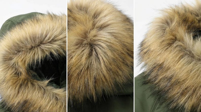 K&ouml;nnte beinhalten: Nahaufnahme einer gr&uuml;nen Parka-Kapuze mit Kunstfellbesatz. Das Fell hat eine Mischung aus hellen und dunklen Braunt&ouml;nen, wodurch ein strukturiertes Aussehen entsteht. Die Kapuze ist f&uuml;r W&auml;rme und Schutz konzipiert.