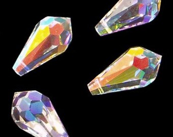 May include: Four iridescent crystal teardrop beads, each with a faceted design.