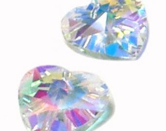 May include: Two iridescent heart-shaped rhinestones. The rhinestones have a faceted surface that reflects light, displaying a spectrum of colors including pink, blue, and yellow. The hearts are set against a white background.