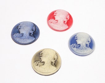 May include: Four cameo-style buttons with a white profile of a woman's face on a colored background. The buttons are blue, red, white, and black.