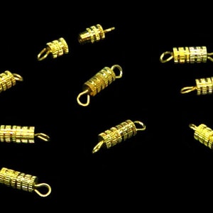 May include: Ten gold-toned metal spring clasps for jewelry making. Each clasp has a coil design and two loops for attaching to a necklace or bracelet.
