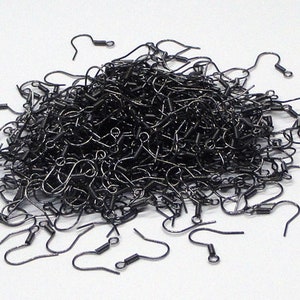 May include: A large pile of black earring hooks. The hooks are made of metal and have a spring-loaded closure.
