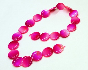 May include: A pink and white iridescent necklace made of round, flat beads.