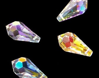 May include: Four iridescent teardrop-shaped crystal beads in different colors: purple, gold, blue, and clear.