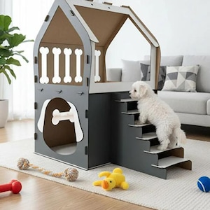 May include: A gray and white dog house with bone-shaped cutouts and a small staircase. A white dog is climbing the stairs. Toys, including a rope toy, a yellow duck, and a blue ball, are scattered on the floor.