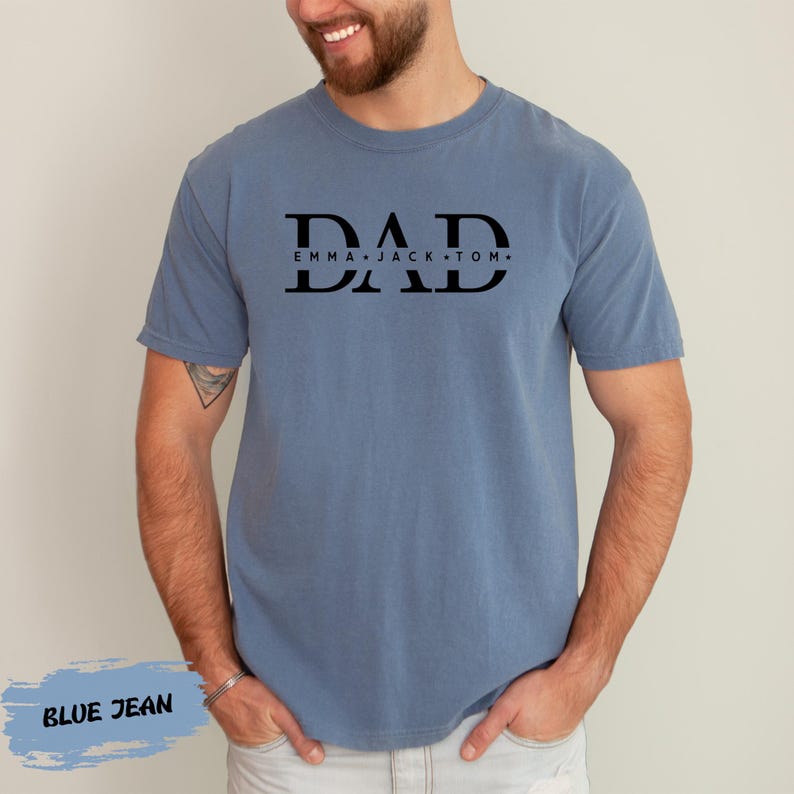 A man wearing a blue t-shirt with the text "DAD" printed on it.