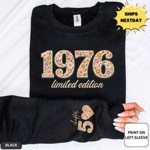 May include: Black sweatshirt with the year "1976" in a floral design, with the words "limited edition" below. The left sleeve has a floral heart and the number "55" with the word "chapter".